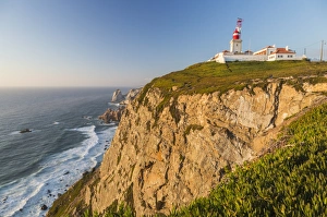 The Cabo da Roca lighthouse overlooks the promontory towards the Atlantic Ocean at sunset The Cabo da Roca lighthouse overlooks the promontory towards the Atlantic Ocean at sunset
