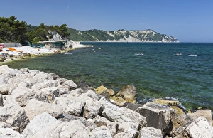 Canoe in the bay surrounded by the turquoise sea, Province of Ancona, Conero Riviera Canoe in the bay surrounded by the turquoise sea, Province of Ancona, Conero Riviera