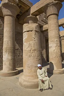 Caretaker, Columns with Reliefs, Temple of Sobek and Haroeris, Kom Ombo, Egypt Caretaker, Columns with Reliefs, Temple of Sobek and Haroeris, Kom Ombo, Egypt