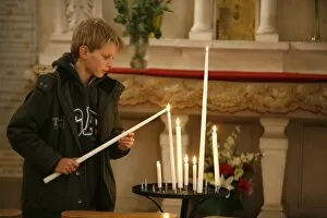 Images Dated 23rd December 2007: Child lighting a church candle, Toucy, Yonne, France, Europe