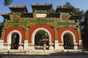 Chinese girl under a glazed archway at the Confucius Temple Imperial College built in 1306 by the grandson of Kublai Chinese girl under a glazed archway at the Confucius Temple Imperial College built in 1306 by the grandson of Kublai