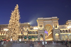 Christmas tree and Galleria Vittorio Emanuele entrance illuminated at dusk Christmas tree and Galleria Vittorio Emanuele entrance illuminated at dusk