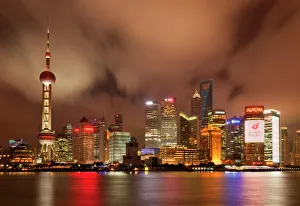 City skyline at night with Oriental Pearl Tower and Pudong skyscrapers across the Huangpu City skyline at night with Oriental Pearl Tower and Pudong skyscrapers across the Huangpu