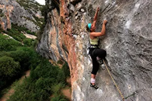 Climber makes her way up one of the rock faces of the celebrated Mascun Gorge Climber makes her way up one of the rock faces of the celebrated Mascun Gorge