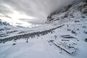 Clouds over the snowy slopes of Sella Pass ski area, Val Gardena, Dolomites Clouds over the snowy slopes of Sella Pass ski area, Val Gardena, Dolomites