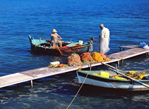 Images Dated 18th June 2010: Corfu Fisherman and Wife Cleaning Nets Print