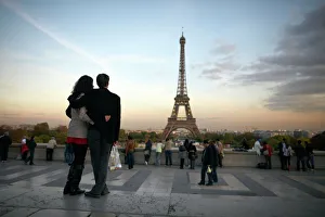 A couple look towards the Eiffel Tower, Paris, France, Europe A couple look towards the Eiffel Tower, Paris, France, Europe