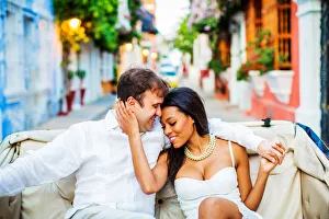 Couple sitting in a horse and carriage, Old Walled-in City, Cartagena, Colombia Couple sitting in a horse and carriage, Old Walled-in City, Cartagena, Colombia