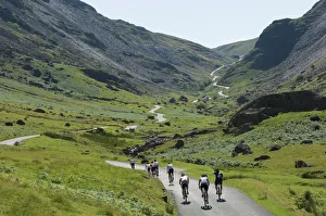 Cyclists ascending Honister Pass, Lake District National Park, Cumbria, England, United Kingdom, Europe Cyclists ascending Honister Pass, Lake District National Park, Cumbria, England, United Kingdom, Europe