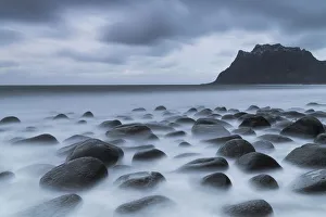 Dark clouds over Uttakleiv beach and stones washed by sea, Leknes, Vestvagoy, Nordland, Lofoten Islands, Norway Dark clouds over Uttakleiv beach and stones washed by sea, Leknes, Vestvagoy, Nordland, Lofoten Islands, Norway