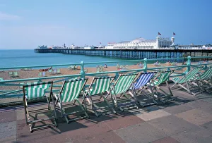 Prints of Deckchairs above the beach and the Palace Pier at Brighton, Sussex, England, United Kingdom, Europe Palace Prints: Deckchair Print of Brighton Beach Scene