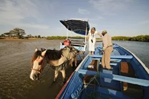 Saloum Delta Collection: Delivering passangers to pirogue or fishing boat on the backwaters of the Sine Saloum delta