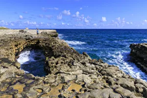 Antigua And Barbuda Travel Guide Prints: Devils Bridge, limestone rock formation and arch, tourist takes selfie, Antigua
