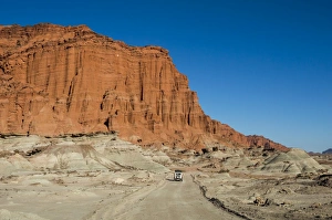 Driving past red Los Coloradas Cliff, Valley of the Moon (Valle de la Luna), Ischigualasto Driving past red Los Coloradas Cliff, Valley of the Moon (Valle de la Luna), Ischigualasto
