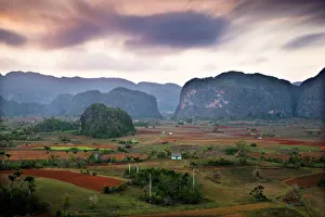Dusk view across Vinales Valley showing limestone hills known as Mogotes Dusk view across Vinales Valley showing limestone hills known as Mogotes