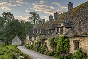 Early Spring morning view of the beautiful Cotswolds cottages at Arlington Row in Bibury Early Spring morning view of the beautiful Cotswolds cottages at Arlington Row in Bibury