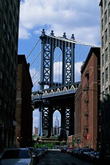 Empire State Building in distance seen through Manhattan Bridge Empire State Building in distance seen through Manhattan Bridge