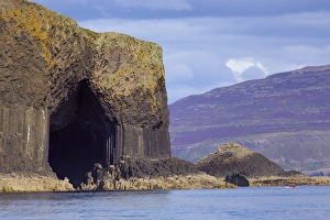 Fingals Cave, the hexagonal mouth of the cave with the heather-covered slopes of Mull Fingals Cave, the hexagonal mouth of the cave with the heather-covered slopes of Mull