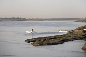 A fisherman checks his nets on the Nile river at Karima A fisherman checks his nets on the Nile river at Karima