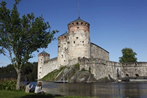 Girls relaxing beside Olavinlinna Medieval Castle (St. Olafs Castle) Girls relaxing beside Olavinlinna Medieval Castle (St. Olafs Castle)
