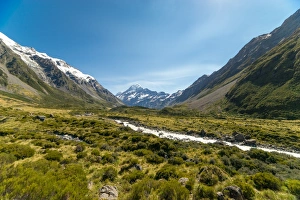 A glacier fed creek cuts through a green valley high in the mountains, South Island A glacier fed creek cuts through a green valley high in the mountains, South Island