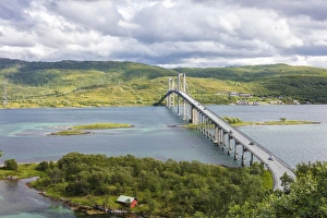 Green hills and turquoise sea frame the suspension road bridge in Tjeldsundbrua, Troms county Green hills and turquoise sea frame the suspension road bridge in Tjeldsundbrua, Troms county