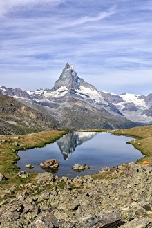 Hikers admire the Matterhorn reflected in Lake Stellisee, Zermatt, Canton of Valais Hikers admire the Matterhorn reflected in Lake Stellisee, Zermatt, Canton of Valais