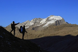 Hikers admire the view of Alpi Graie (Graian Alps) landscape, Gran Paradiso National Park Hikers admire the view of Alpi Graie (Graian Alps) landscape, Gran Paradiso National Park