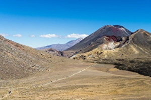 Hikers are dwarfed by the volcanic Mount Ngauruhoe on the Tongariro Crossing trail Hikers are dwarfed by the volcanic Mount Ngauruhoe on the Tongariro Crossing trail