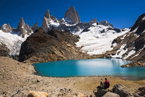 Hikers at Lago de los Tres (Laguna de los Tres) with Mount Fitz Roy (Cerro Chalten) behind Hikers at Lago de los Tres (Laguna de los Tres) with Mount Fitz Roy (Cerro Chalten) behind