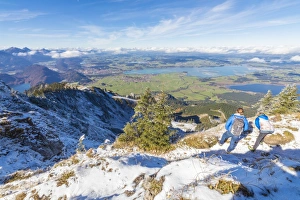 Hikers on steep crest covered with snow in the Ammergau Alps, Tegelberg, Fussen, Bavaria Hikers on steep crest covered with snow in the Ammergau Alps, Tegelberg, Fussen, Bavaria