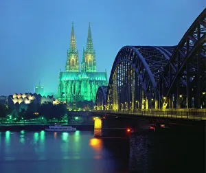 Hohenzollernbrucke and the Cathedral Illuminated at Night, Cologne, Germany Hohenzollernbrucke and the Cathedral Illuminated at Night, Cologne, Germany