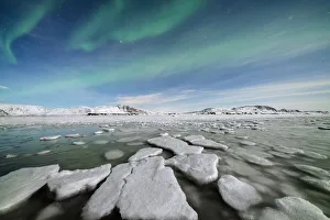 Ice blocks in the frozen Arctic sea lit by Northern Lights (Aurora Borealis) Ice blocks in the frozen Arctic sea lit by Northern Lights (Aurora Borealis)