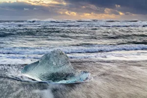 Iceberg from melting glacier on black sand beach near Jokulsarlon glacier lagoon, Vatnajokull National Park, Iceland Iceberg from melting glacier on black sand beach near Jokulsarlon glacier lagoon, Vatnajokull National Park, Iceland