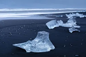 Icebergs from melting glacier on black sand beach near Jokulsarlon glacier lagoon, Vatnajokull National Park, Iceland Icebergs from melting glacier on black sand beach near Jokulsarlon glacier lagoon, Vatnajokull National Park, Iceland