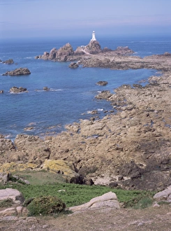 Jersey Lighthouse Prints: Lighthouse from cliffs at low tide, Corbiere, St. Brelade, Jersey, Channel Islands