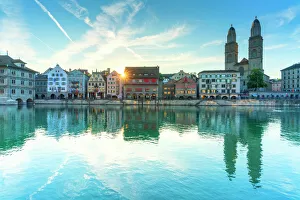 Limmatquai and Grossmunster Cathedral mirrored in Limmat River at dawn, Zurich Limmatquai and Grossmunster Cathedral mirrored in Limmat River at dawn, Zurich