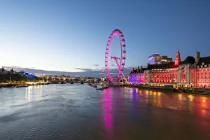 The London Eye lit up pink during blue hour, and River Thames, London, England The London Eye lit up pink during blue hour, and River Thames, London, England