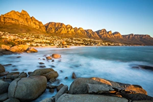 Long exposure at sunset in Camps Bay with Table Mountain and its cable car on the left Long exposure at sunset in Camps Bay with Table Mountain and its cable car on the left