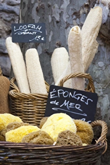 Loofahs and sponges shaped like baguettes and bread in the Saturday market, Ceret, France, Europe Loofahs and sponges shaped like baguettes and bread in the Saturday market, Ceret, France, Europe