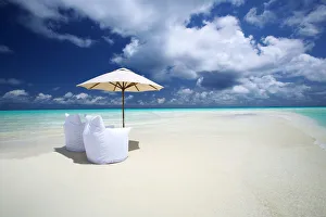 Two Lounge Chairs and Parasol on empty Beach, The Maldives, Indian Ocean, Asia Two Lounge Chairs and Parasol on empty Beach, The Maldives, Indian Ocean, Asia
