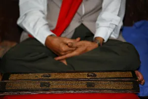 Man reading Buddhist scriptures Print