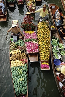 Market traders in boats selling flowers and fruit Market traders in boats selling flowers and fruit