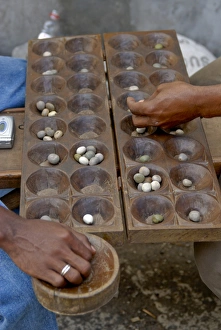 Men playing Kalah (Kalaha) (Mancala), a game in the mancala family, Moroni Men playing Kalah (Kalaha) (Mancala), a game in the mancala family, Moroni