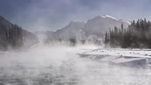 Mist rising off the waters of the Bow River in sub-zero winter weather, Canmore, Alberta Mist rising off the waters of the Bow River in sub-zero winter weather, Canmore, Alberta