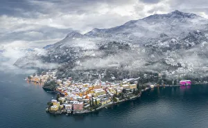 Mist over Varenna old town and Lake Como after a snowfall in winter, aerial view Mist over Varenna old town and Lake Como after a snowfall in winter, aerial view