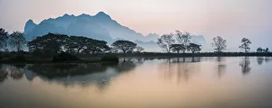 Misty morning at Kyauk Kalap Buddhist Temple at sunrise, Hpa An, Kayin State, Myanmar Misty morning at Kyauk Kalap Buddhist Temple at sunrise, Hpa An, Kayin State, Myanmar