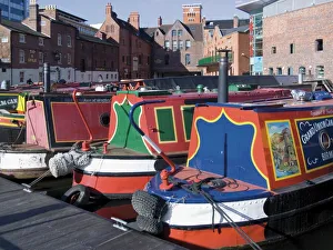 Narrow boats and barges moored at Gas Street Canal Basin, city centre, Birmingham Narrow boats and barges moored at Gas Street Canal Basin, city centre, Birmingham