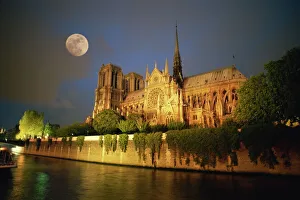 Notre Dame Cathedral at night, with moon rising above, Paris, France, Europe Notre Dame Cathedral at night, with moon rising above, Paris, France, Europe