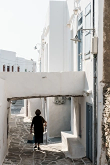 Old lady in black with stick and shopping walking home, Kastro Village, Sifnos, Cyclades Old lady in black with stick and shopping walking home, Kastro Village, Sifnos, Cyclades